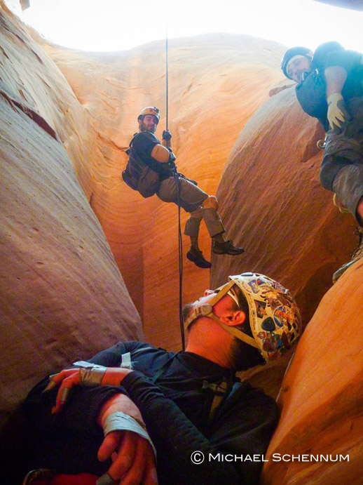 Eric rappels as Chris and David look on. 